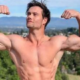 Connor Murphy posing in a gym during his fitness journey, highlighting his muscular physique and online fitness career.