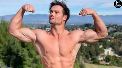 Connor Murphy posing in a gym during his fitness journey, highlighting his muscular physique and online fitness career.